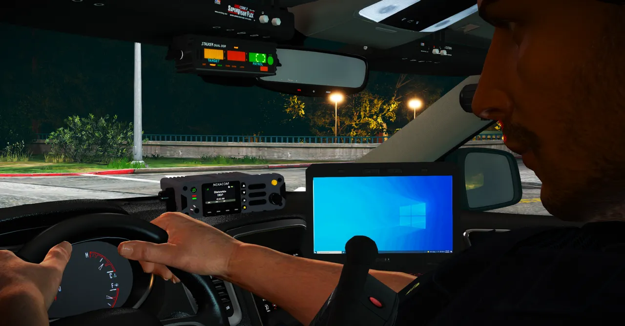 Radio and MDT mounted in a patrol dash at night